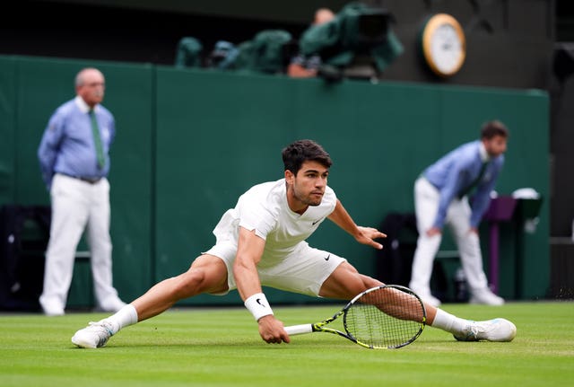 Carlos Alcaraz does the splits on Centre Court at Wimbledon