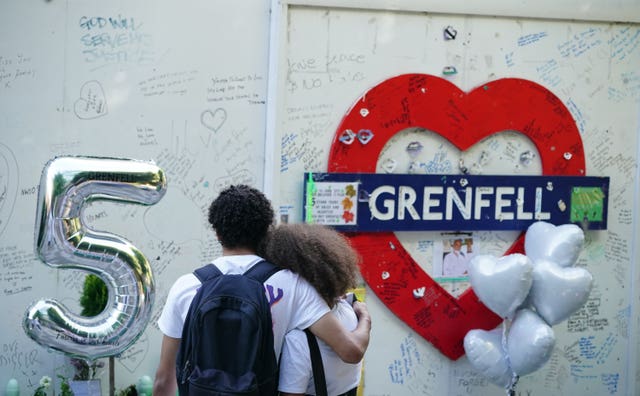 Members of the public at the memorial at the base of Grenfell Tower 