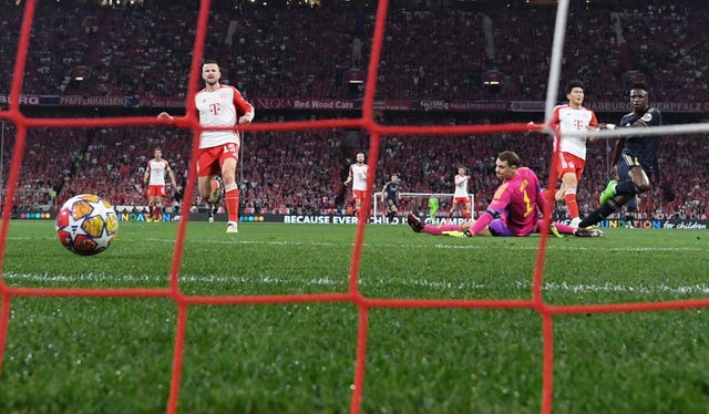 Vinicius Jr, right, scores Real Madrid’s first goal past Bayern Munich keeper Manuel Neuer