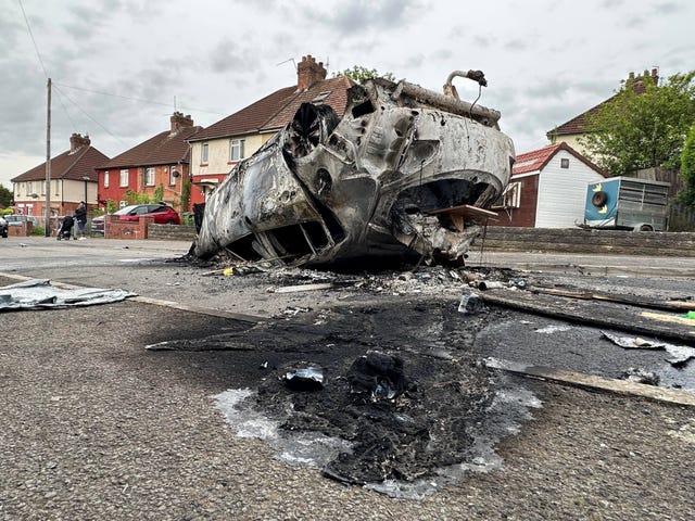 Cars were set alight during the rioting in Ely following the deaths of the two teeangers (PA)