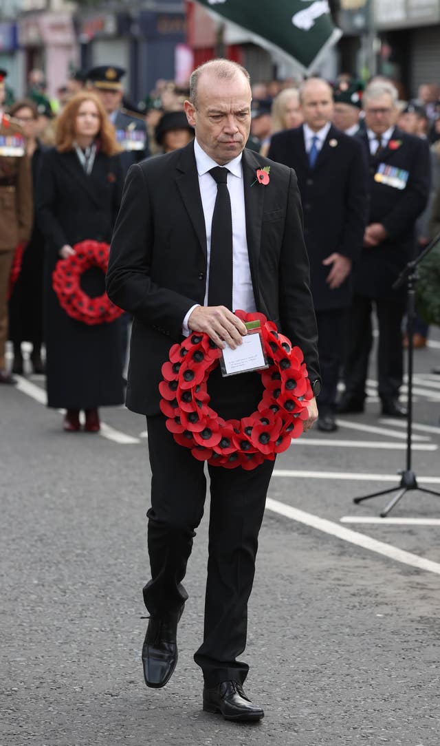Northern Ireland Secretary Chris Heaton-Harris lays a wreath during the service 