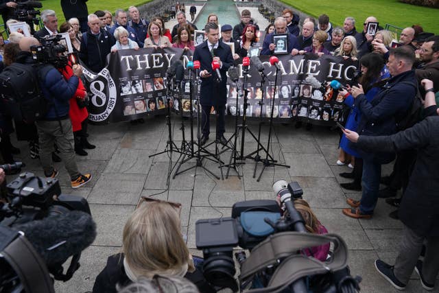 Darragh Mackin speaking to the media in front of survivors, family members and supporters after a verdict of unlawful killing was returned in the Stardust fire inquest