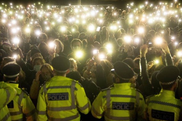 Members of the crowd shine lights from their phones at the vigil for Sarah Everard in March