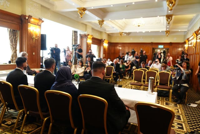 Solictor Aamer Anwar with brothers, Muhammad Amaad, 25, (right) Fahir Amaaz, 19, and thier mother Shameem Akhtar, 56, facing the media during a press conference at the Midland Hotel in Manchester