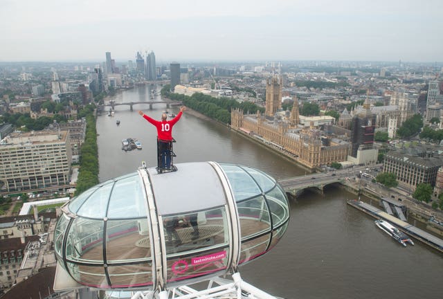 England 1966 World Cup winner Sir Geoff Hurst stands on top of a pod on the London Eye looking out towards Wembley Stadium