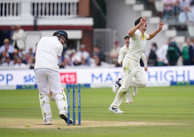 Pat Cummins, right, celebrates the wicket of England’s Harry Brook, left