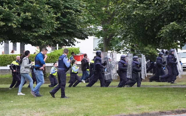 Gardai in riot gear charge at protesters