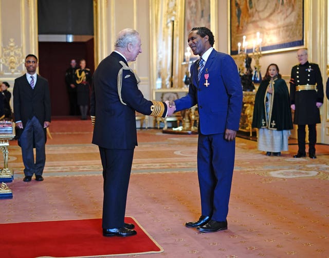 Lemn Sissay being made an OBE by the Prince of Wales during an investiture ceremony at Windsor Castle