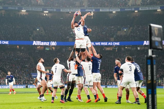 England’s George Martin, top left, wins a line-out ball against France