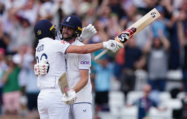 England’s Chris Woakes and Mark Wood, left, celebrate following their victory 