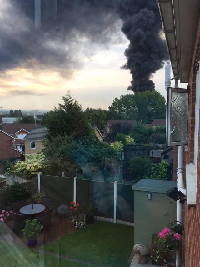 A fire involving a large quantity of tyres and light goods in Salford caused a huge plume of smoke to drift over Manchester
