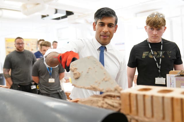 Rishi Sunak tries his hand at bricklaying during a visit to Cannock College