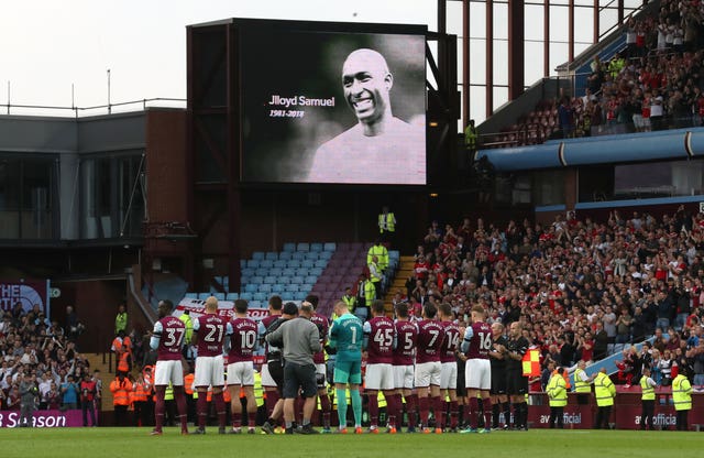 Aston Villa players and fans taking part in a minute's applause in memory of Jlloyd Samuel 