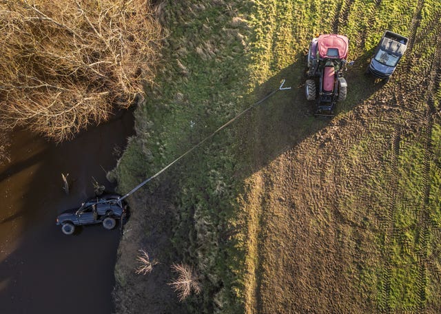 Submerged vehicle tethered to tractor