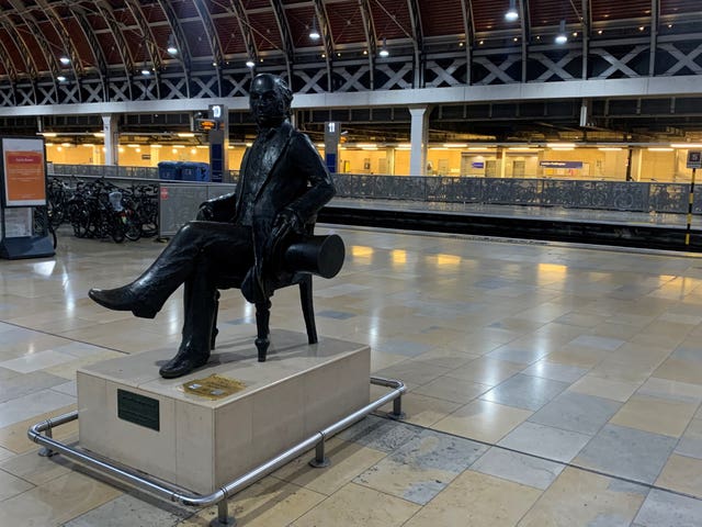 A statue of Isambard Kingdom Brunel sits on an empty platform at Paddington railway station (Peter Clifton/PA)