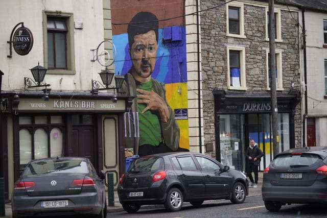 People pass a mural of Ukrainian president Volodymyr Zelensky in County Longford, Ireland 