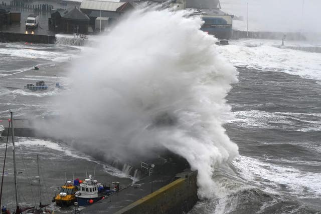 Waves crash on the harbour wall at Stonehaven in Aberdeenshire