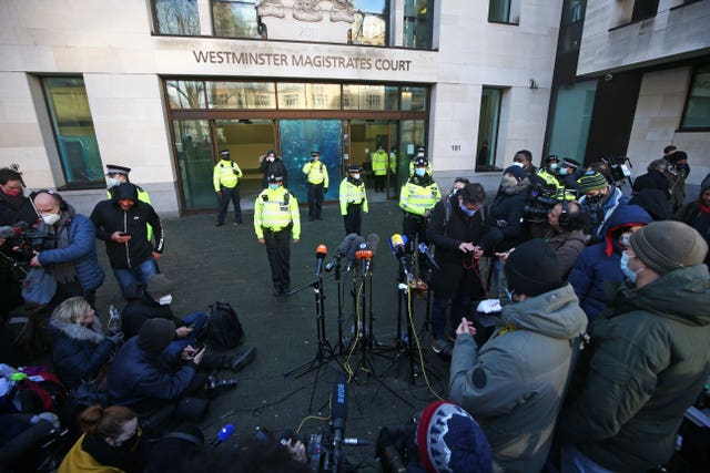 Police officers and members of the media outside Westminster Magistrates’ Court, London