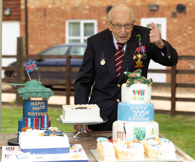 Second World War veteran Captain Tom Moore with birthday cakes as he celebrates his 100th birthday