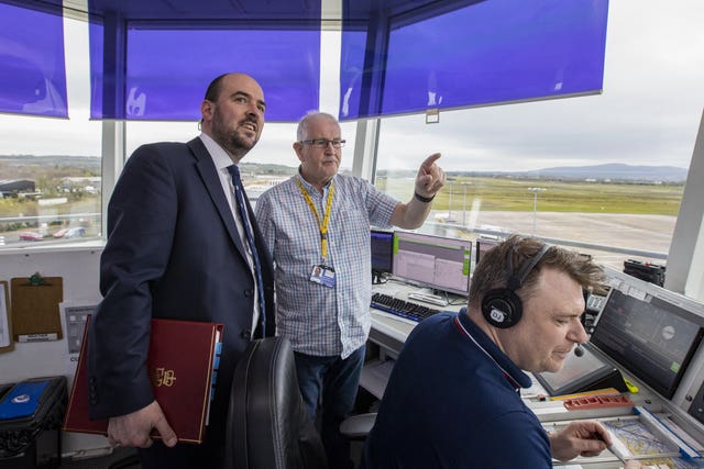 Transport Minister Richard Holden (left) with Air Traffic Controller Alistiar Hunter (centre), during a visit to the City of Derry Airport 