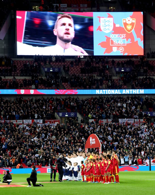 The teams line up for the national anthems