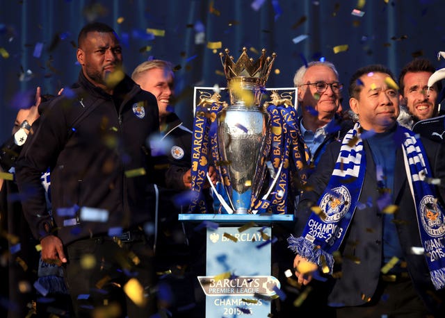 Leicester manager Claudio Ranieri (centre right) and captain Wes Morgan, left, with the Premier League trophy during the team's open top bus parade through Leicester city centre