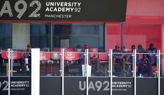 West Indies players look on from the dressing room balcony at Old Trafford