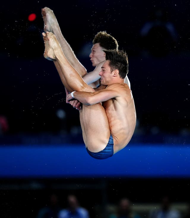 Daley and Williams diving, with their legs straight and tucked into their bodies