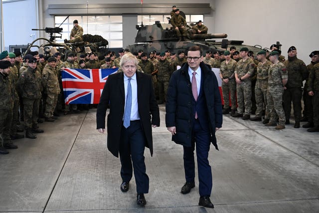 Prime Minister Boris Johnson with British troops during a visit with Polish Prime Minister Mateusz Morawiecki to Warszawska Brygada Pancerna military base near Warsaw 