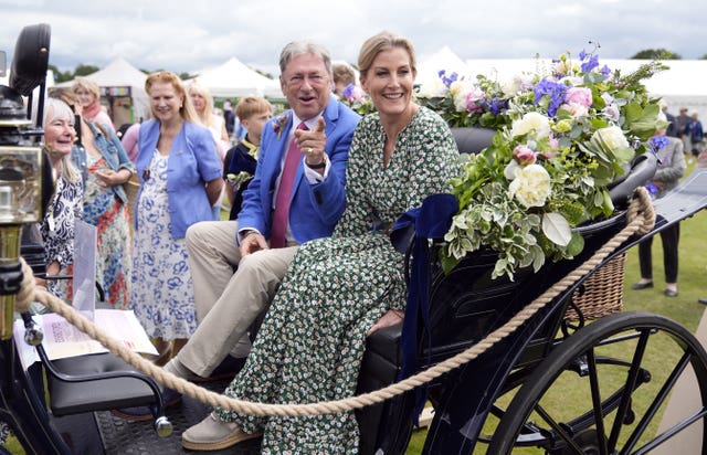 The Duchess of Edinburgh (right) and Alan Titchmarsh, sit in a carriage as they attend the Royal Windsor Flower Show at the York Club in Windsor Great Park. 