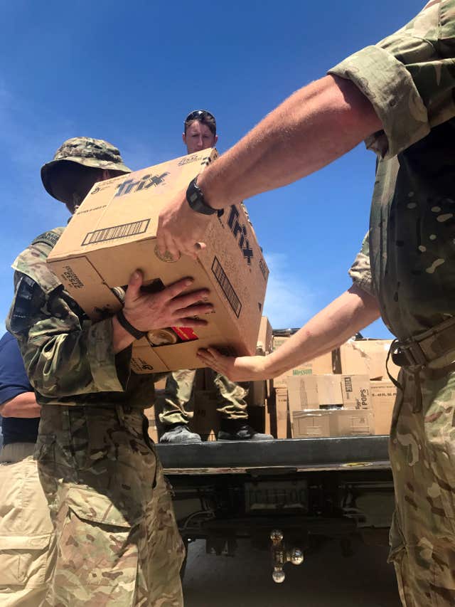 British troops deliver aid on Grand Turk in the Turks and Caicos Islands, a British overseas territory affected by the wrath of Hurricane Irma (Georgina Stubbs/PA)
