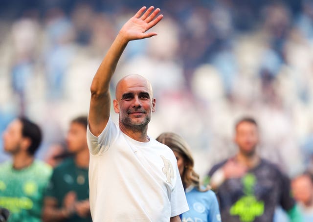 Pep Guardiola waves to fans after Manchester City's match against Aston Villa