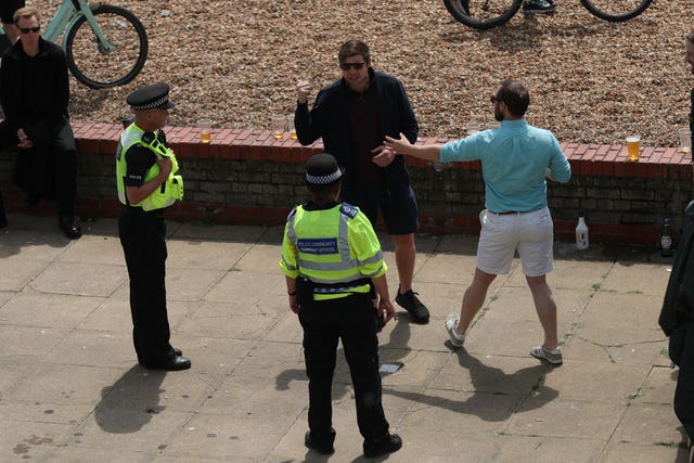 Police talk to people on the sea front