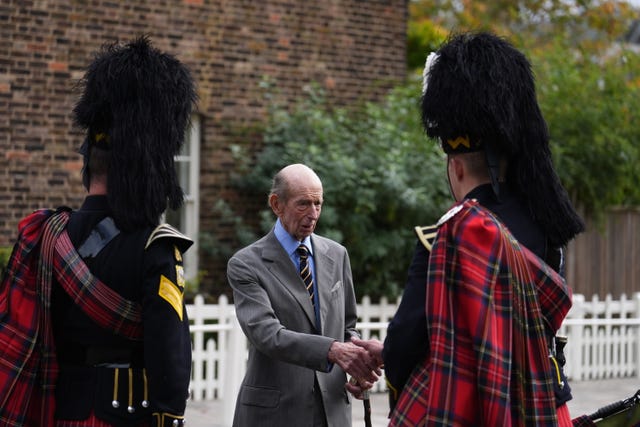 The duke shakes hands with the pipers