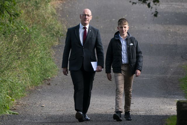 John Swinney and his son walking outside