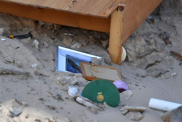 Broken picture frames on the beach after falling from a partially-collapsed house (Joe Giddens/PA)