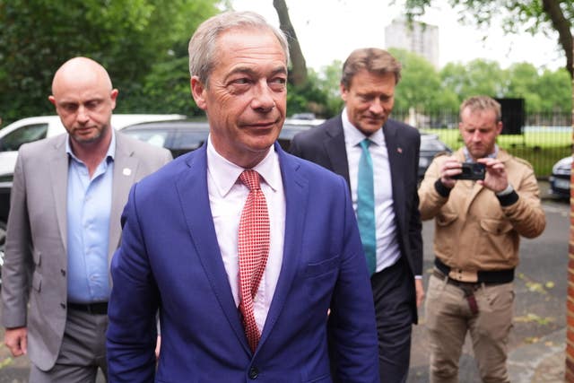 Nigel Farage walking followed by three other men
