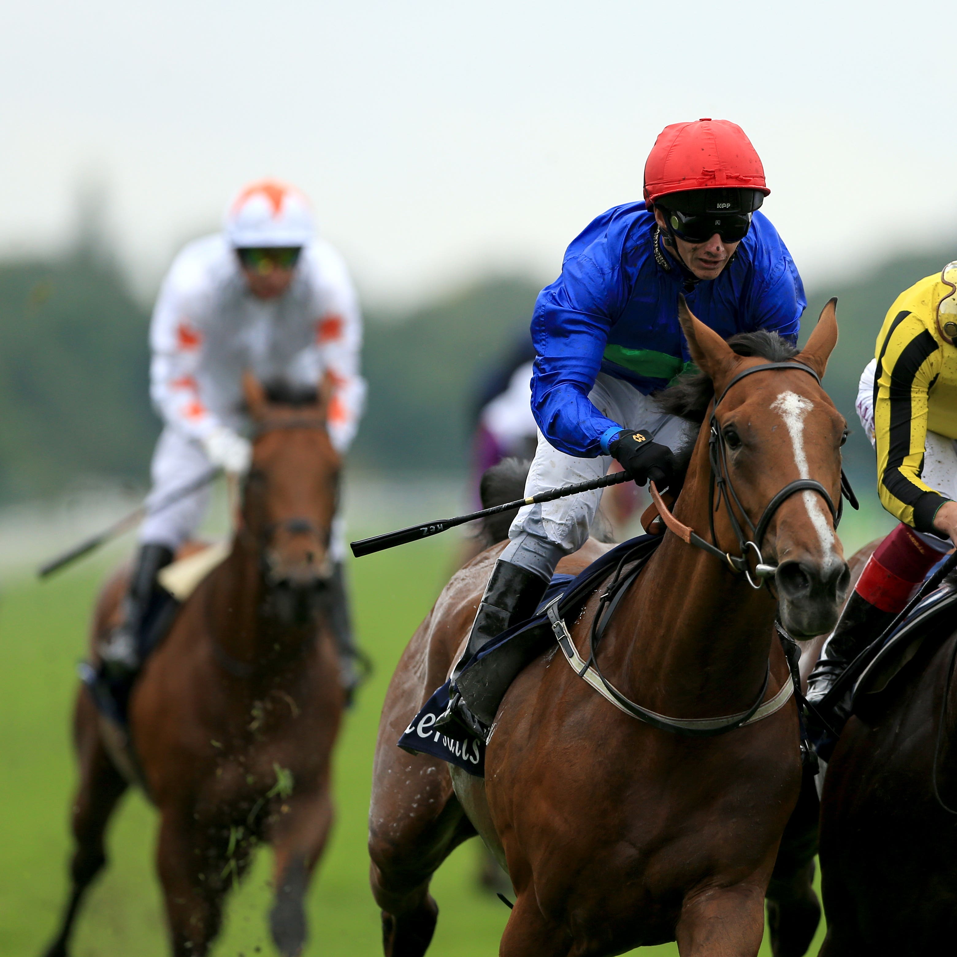Wells Farhh Go (red hat) gets the better of James Garfield in the Acomb Stakes (Tim Goode/PA)