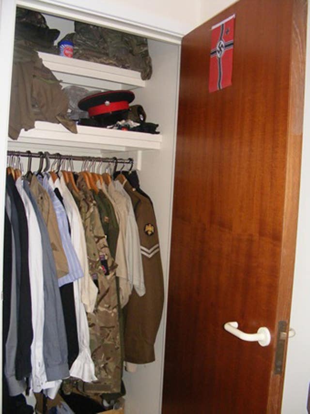 Vehvilainen’s wardrobe containing his Army uniform and a swastika flag stuck to the door