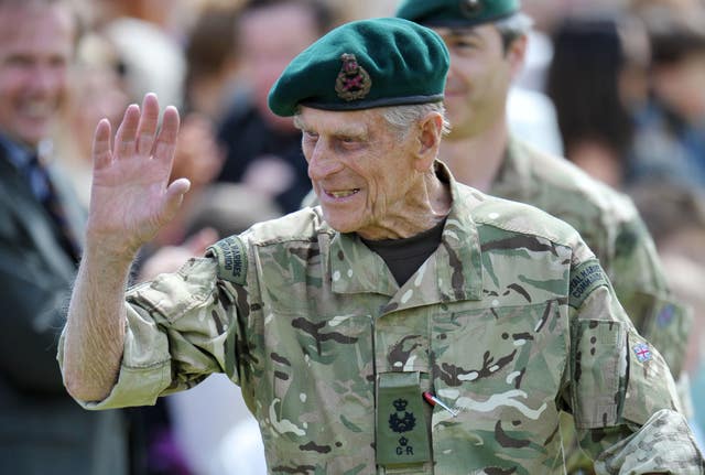 The Duke of Edinburgh waves to the crowd after presenting campaign medals to members of 40 Commando (Tim Ireland/PA)