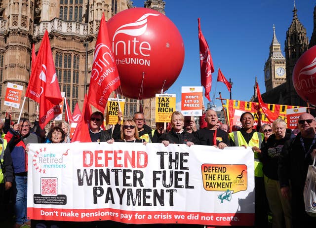 People with a banner protesting against winter fuel payment cuts