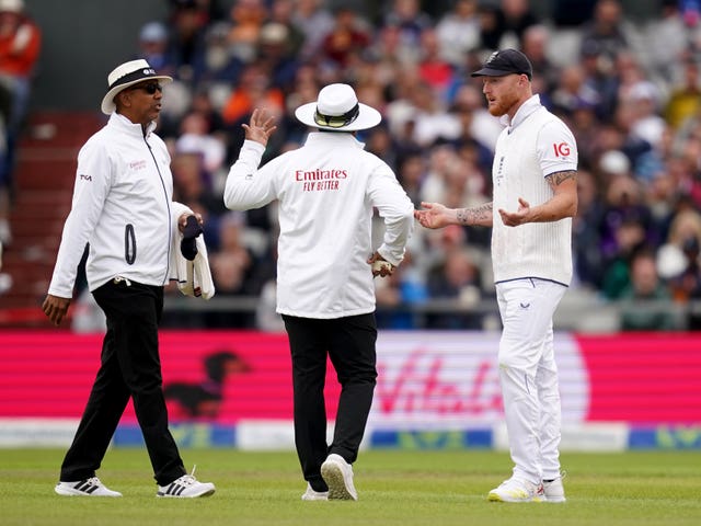 England captain Ben Stokes discusses the light with the umpires.