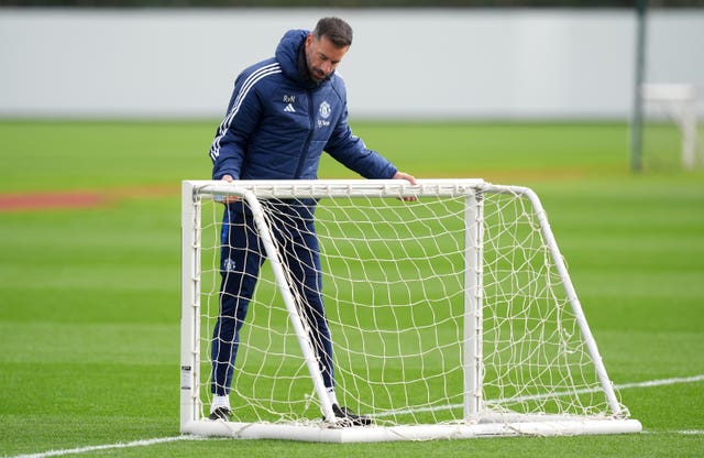 Ruud van Nistelrooy moves a goal during training