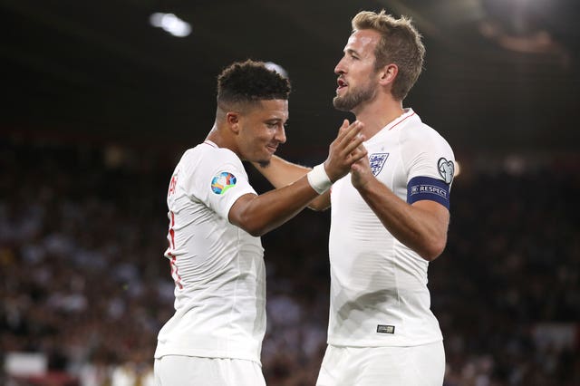 Jadon Sancho celebrates his first goal with Harry Kane, who also scored and had a penalty saved 
