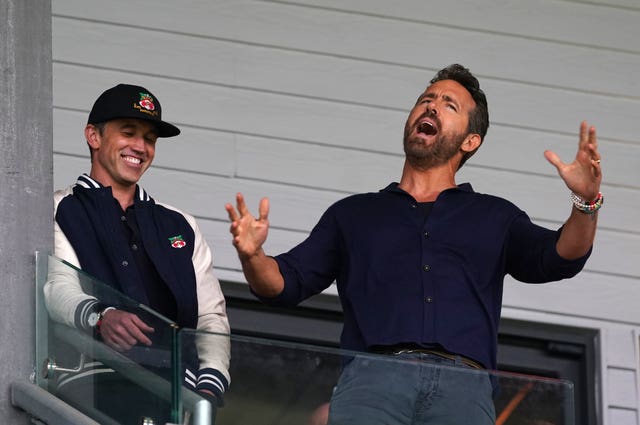 Wrexham co-owners Rob McElhenney (left) and Ryan Reynolds react in the stands