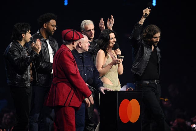 Wolf Alice accept the award for group of the year from Shaun Ryder and Bez during the Brit Awards 2026 at Co-op Live, Manchester