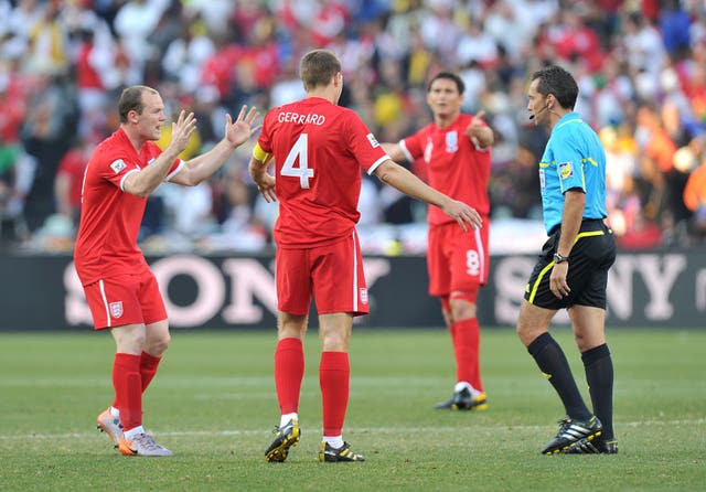 Wayne Rooney (left) and Steven Gerrard (centre) argue with the referee Jorge Larrionda (right) after Lampard's goal was ruled out