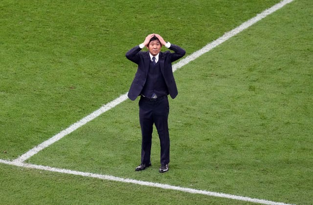 Japan head coach Hajime Moriyasu shows his disbelief after his side's shock win against Germany
