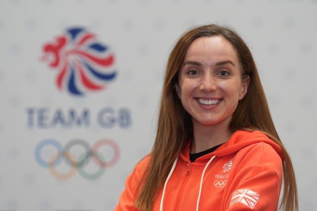 Elinor Barker smiling in front of the Team GB logo.