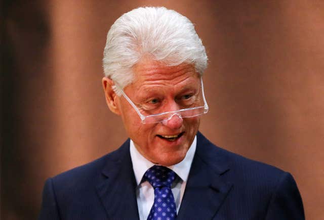 A close-up of a smiling Bill Clinton